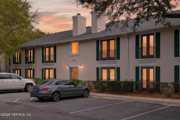 a car parked in front of a brick house