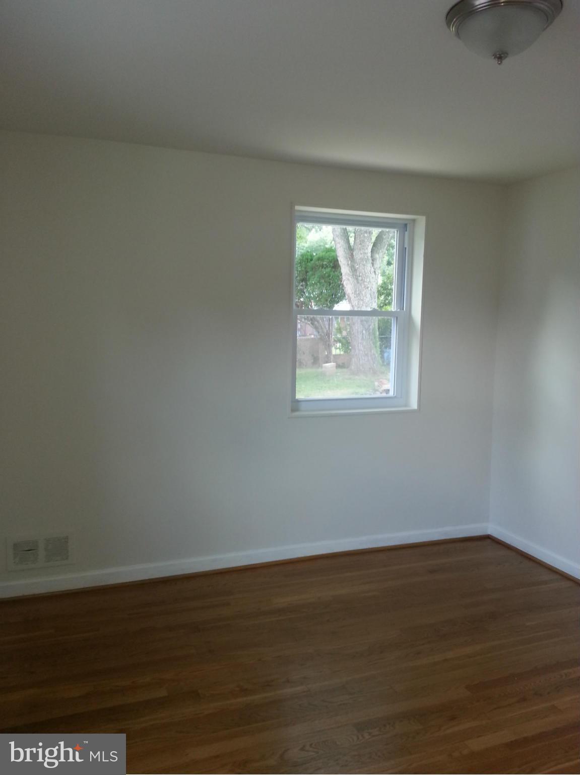 3800 Randolph Road Silver Spring, MD 20902 - Photo 15 of 23 a view of an empty room with wooden floor and a window