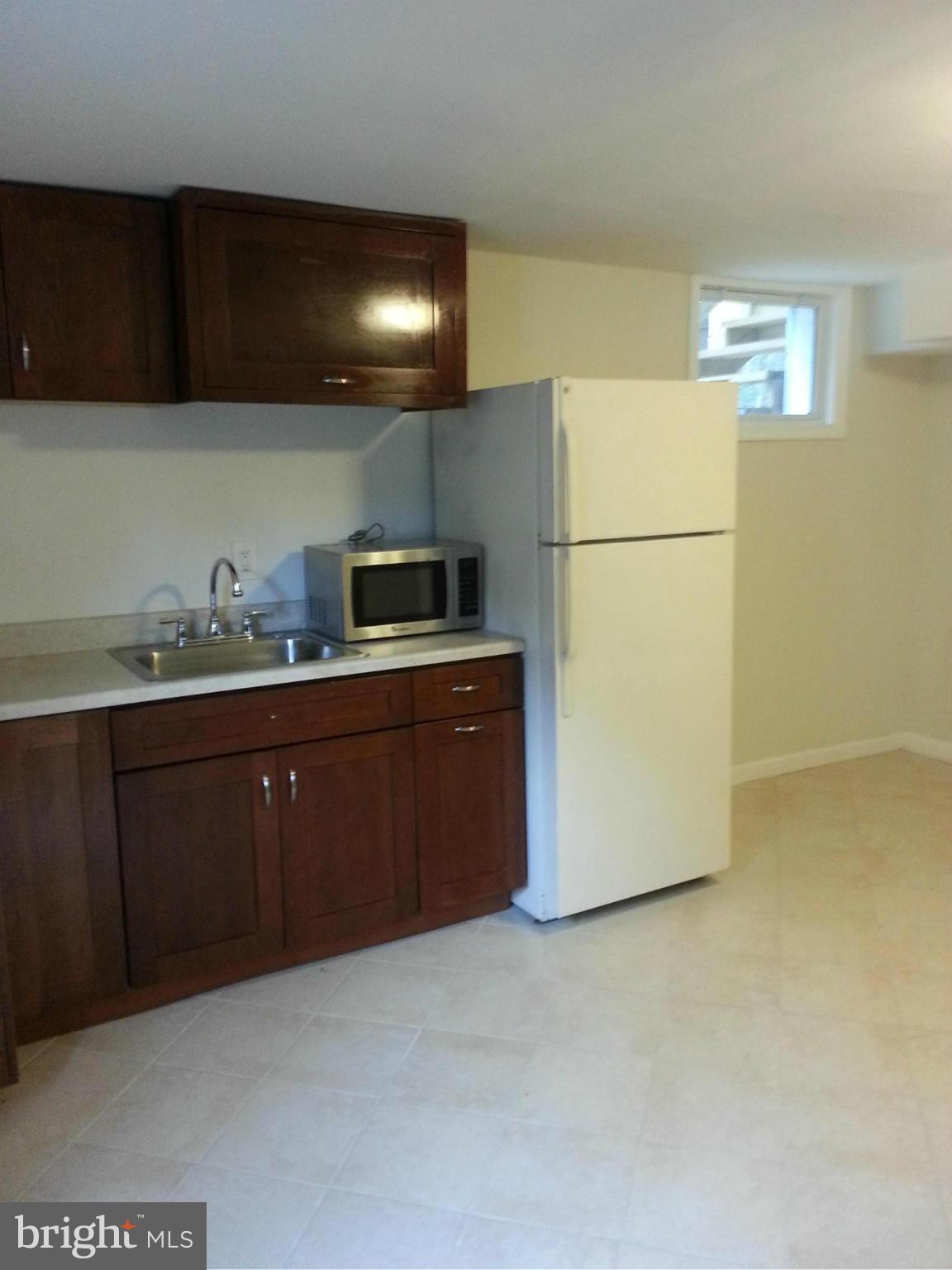 3800 Randolph Road Silver Spring, MD 20902 - Photo 19 of 23 a kitchen with a sink a refrigerator and cabinets