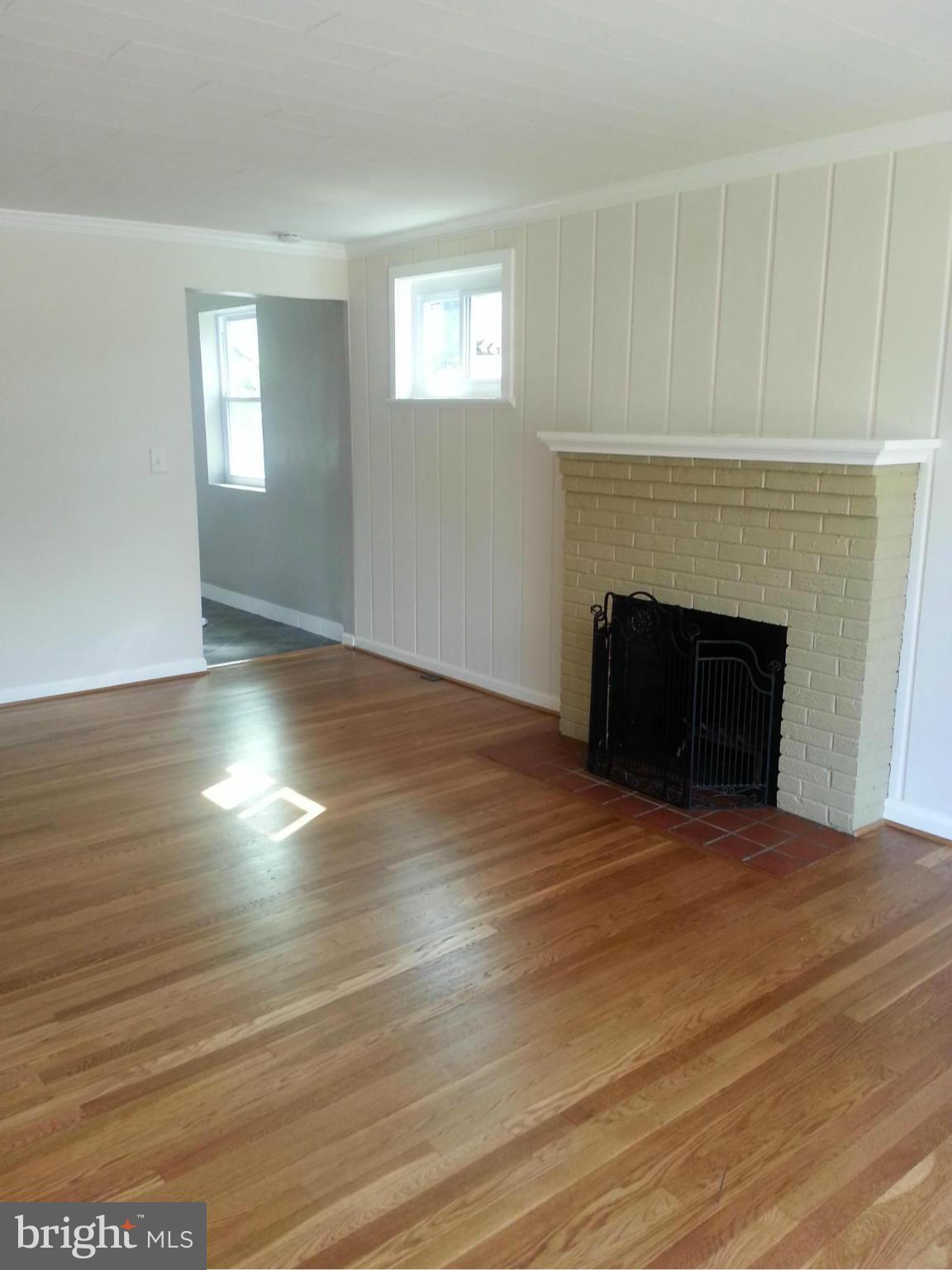3800 Randolph Road Silver Spring, MD 20902 - Photo 5 of 23 a view of empty room with wooden floor and fireplace