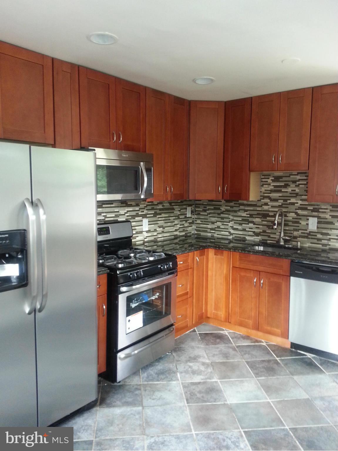 3800 Randolph Road Silver Spring, MD 20902 - Photo 7 of 23 a kitchen with stainless steel appliances granite countertop a stove a refrigerator and a sink