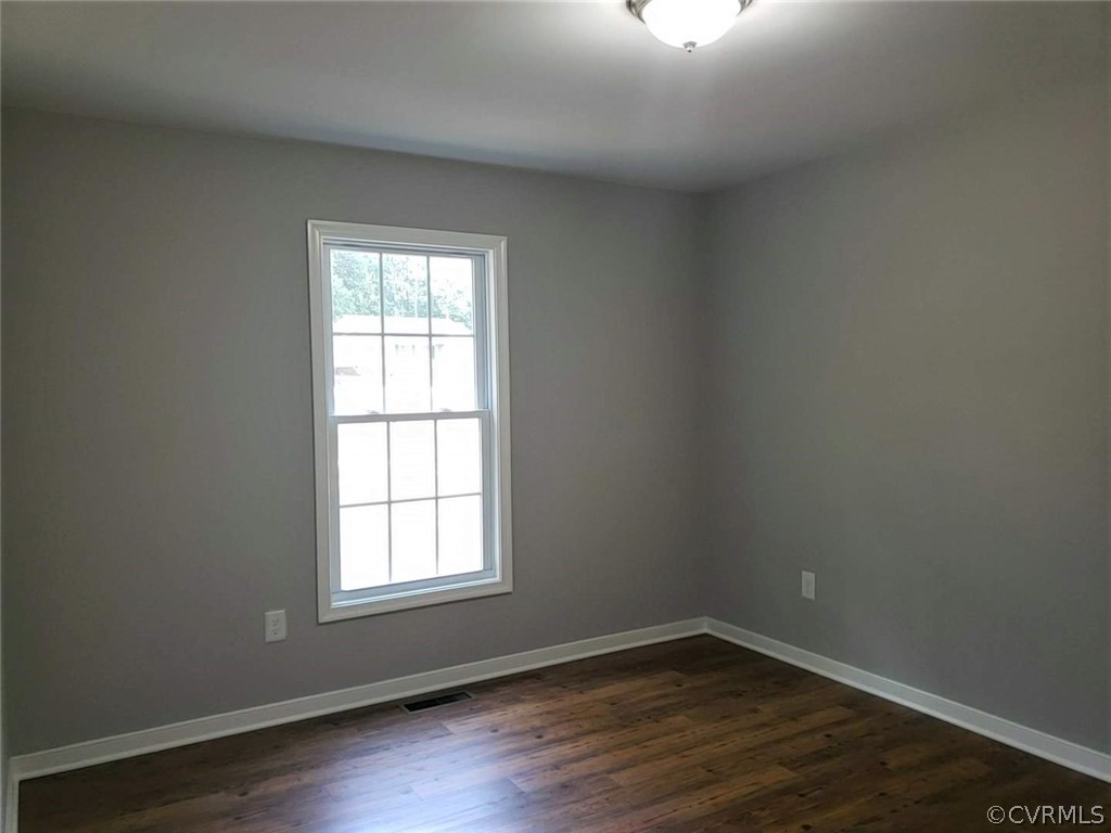 9202 Hunters Trail Road Petersburg, VA 23803 - Photo 11 of 17 an empty room with wooden floor and windows