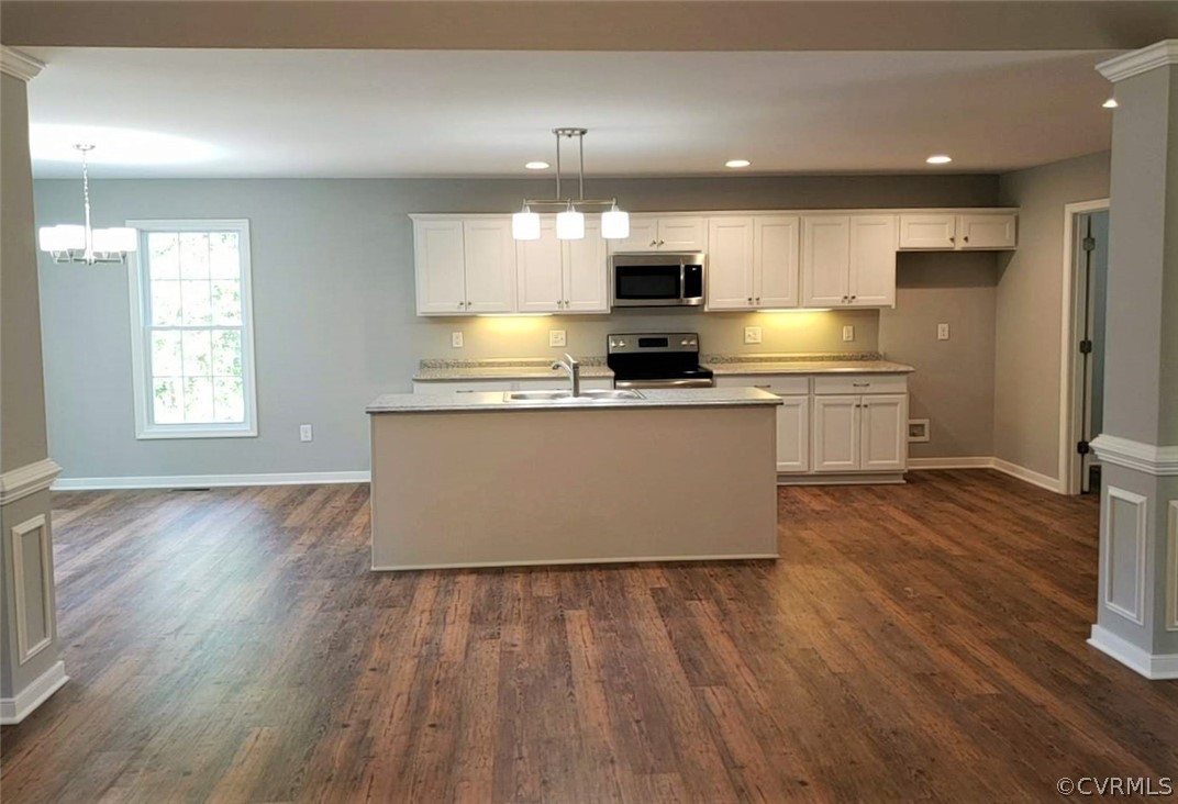 9202 Hunters Trail Road Petersburg, VA 23803 - Photo 5 of 17 a large kitchen with stainless steel appliances a large window a wooden floor and a sink