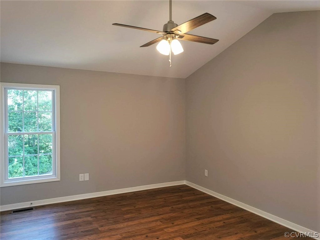 9202 Hunters Trail Road Petersburg, VA 23803 - Photo 9 of 17 an empty room with wooden floor and windows