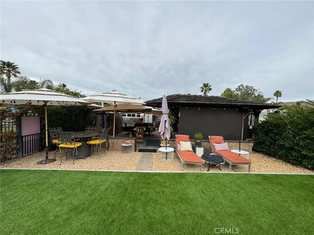 a view of a backyard with sitting area