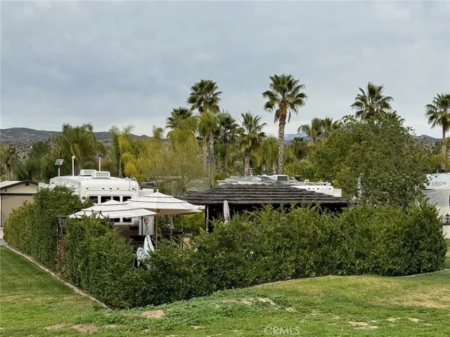 a view of a backyard with sitting area