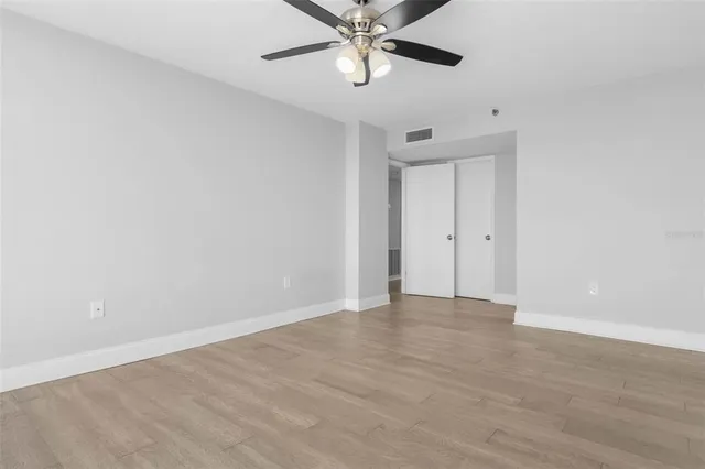 a view of a kitchen with a sink and a refrigerator