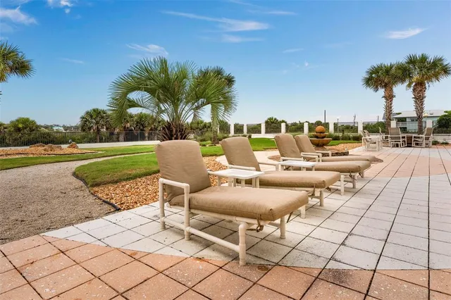 a view of a swimming pool patio and outdoor seating