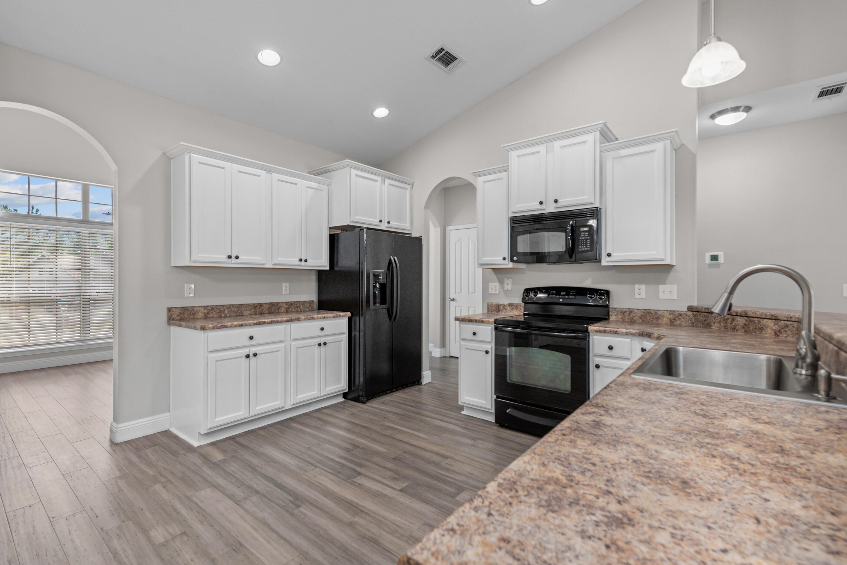 760 Lime Lane Crestview, FL 32536 - Photo 13 of 46 a kitchen with granite countertop a refrigerator stove and sink