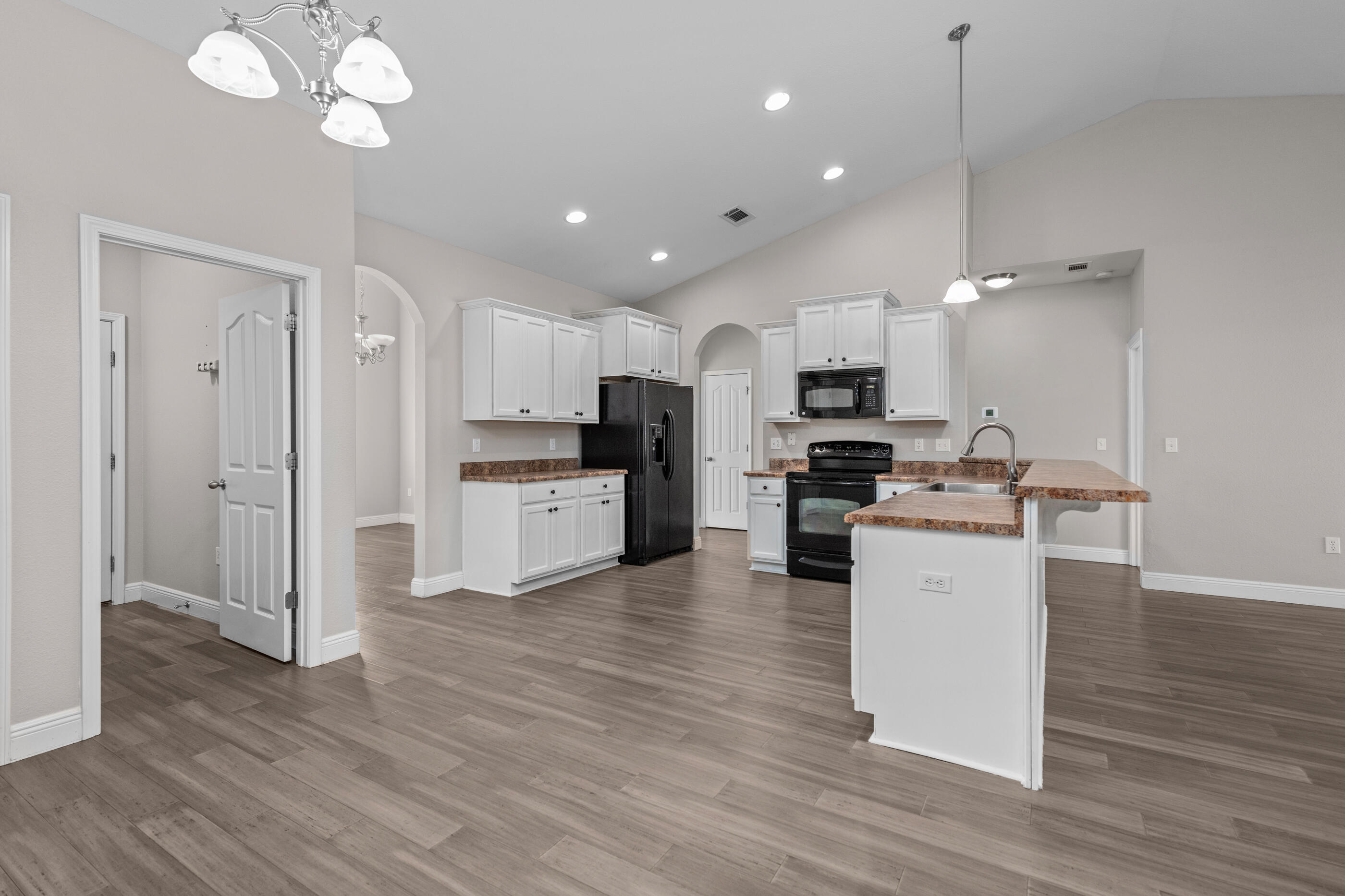 760 Lime Lane Crestview, FL 32536 - Photo 17 of 46 a kitchen with stainless steel appliances granite countertop a refrigerator oven a sink dishwasher and white cabinets with wooden floor