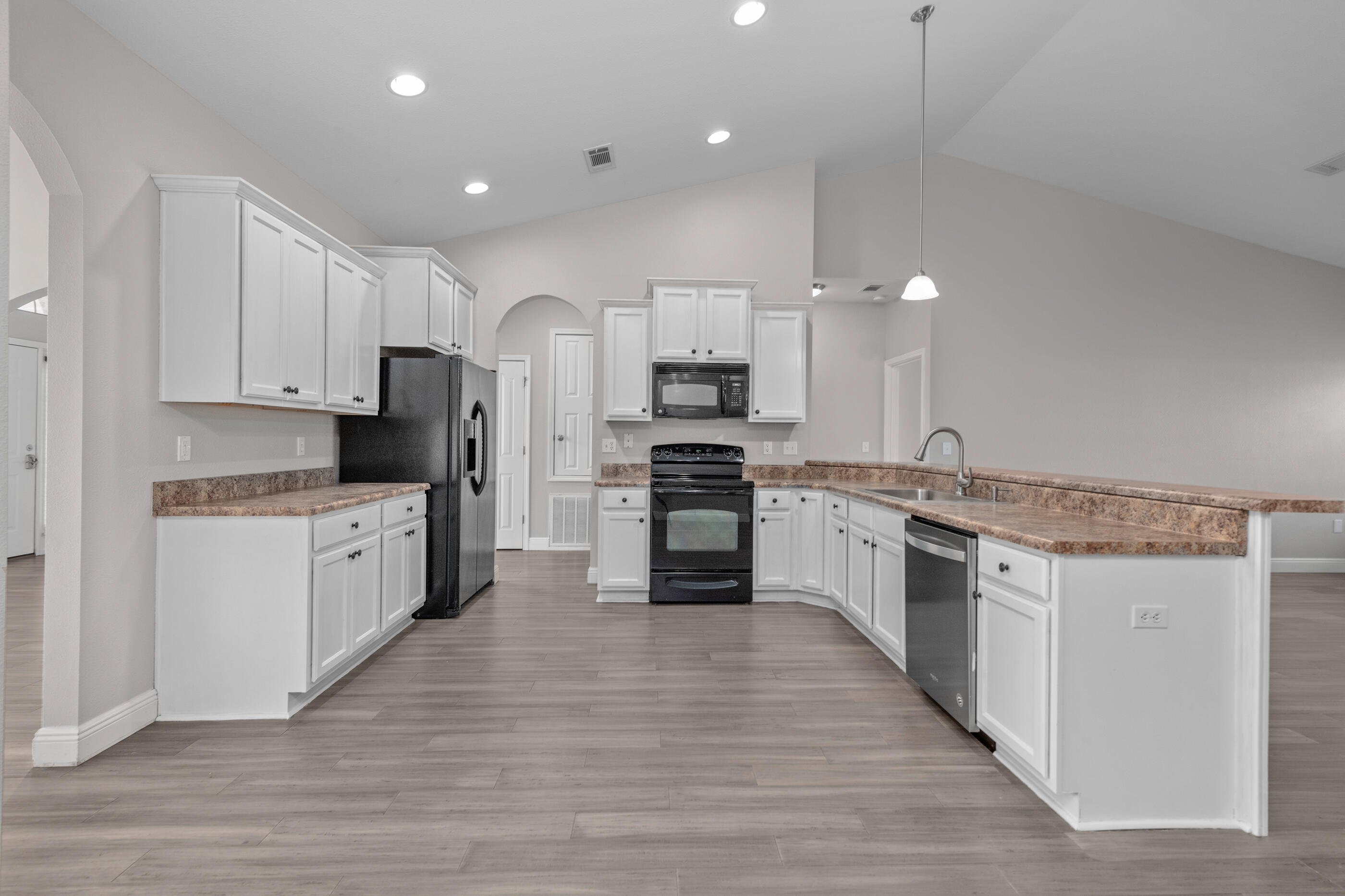 760 Lime Lane Crestview, FL 32536 - Photo 19 of 46 a large kitchen with cabinets wooden floor and stainless steel appliances