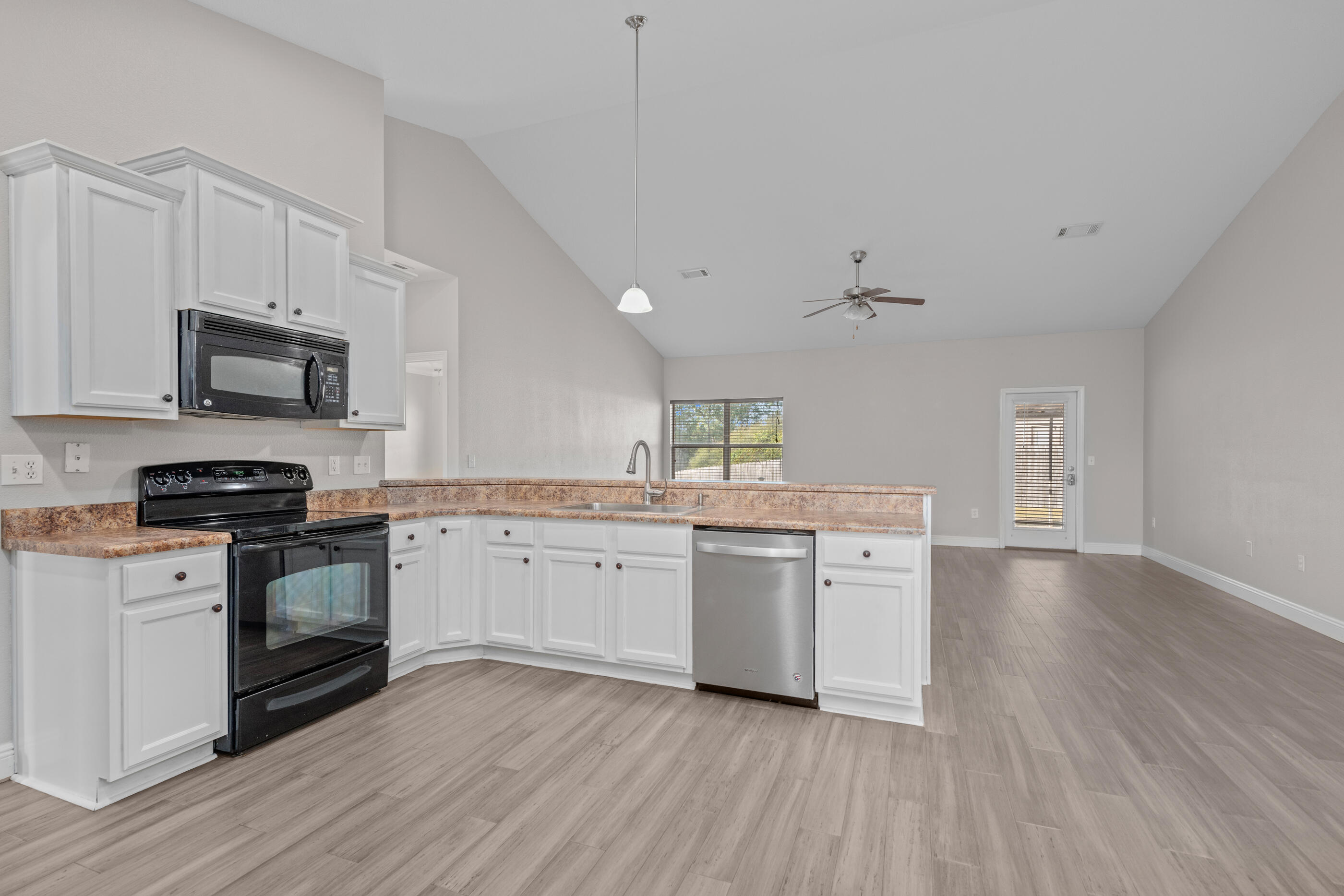 760 Lime Lane Crestview, FL 32536 - Photo 21 of 46 a kitchen with granite countertop white cabinets and stainless steel appliances