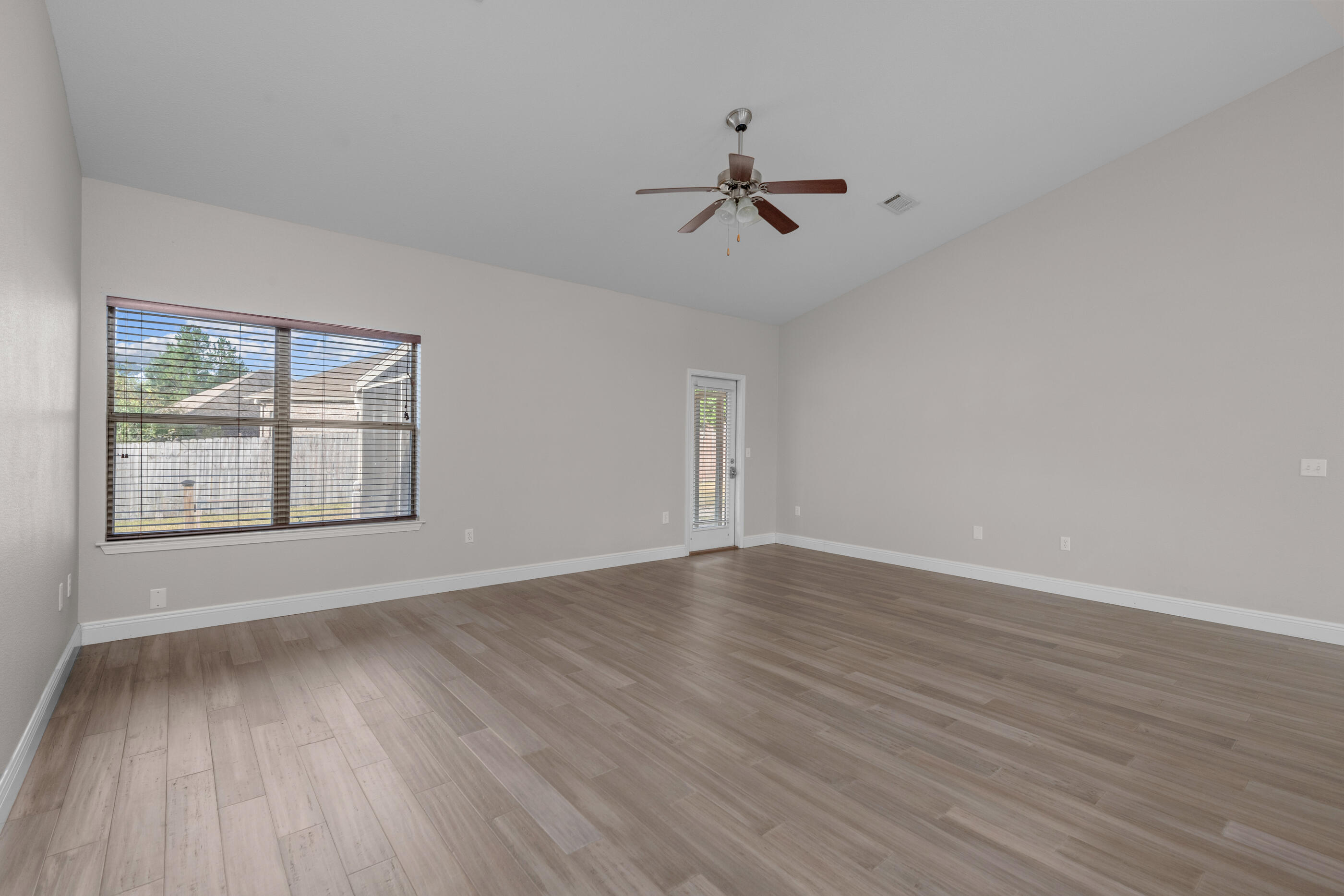 760 Lime Lane Crestview, FL 32536 - Photo 25 of 46 a view of an empty room with wooden floor and a window
