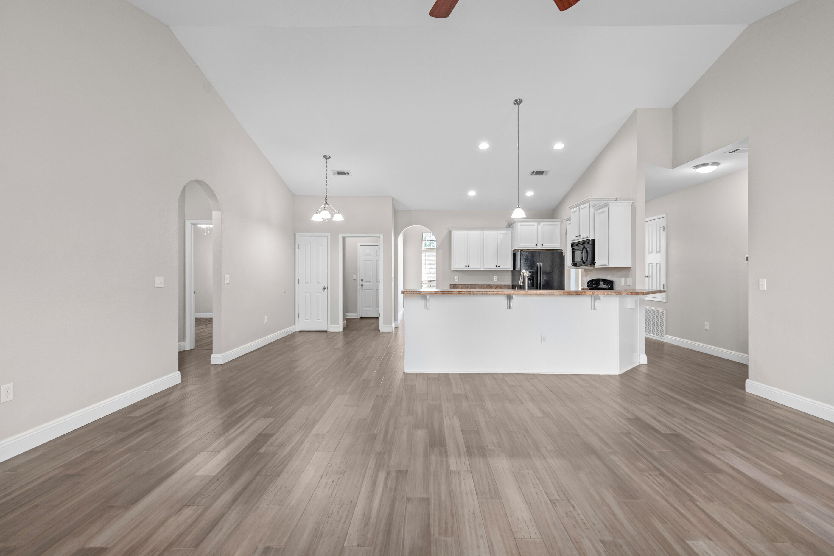 760 Lime Lane Crestview, FL 32536 - Photo 26 of 46 a view of kitchen with kitchen island a sink wooden floor and a refrigerator