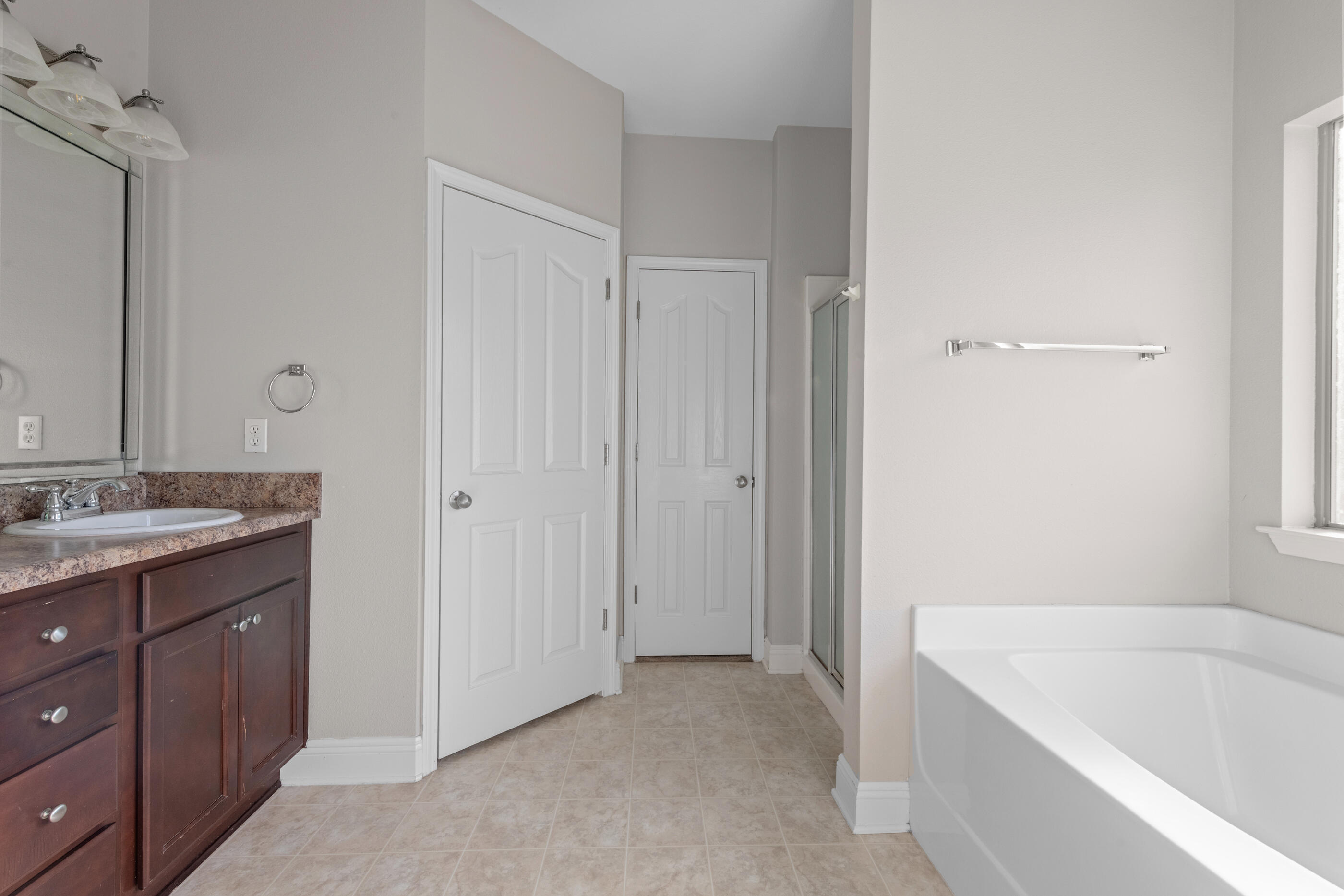 760 Lime Lane Crestview, FL 32536 - Photo 31 of 46 a bathroom with a tub sink and mirror
