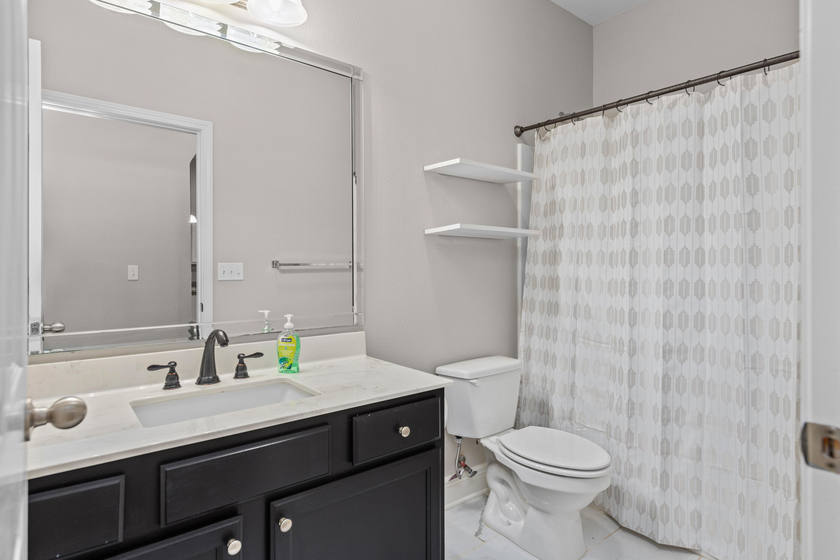 760 Lime Lane Crestview, FL 32536 - Photo 36 of 46 a bathroom with a sink a toilet and shower curtain