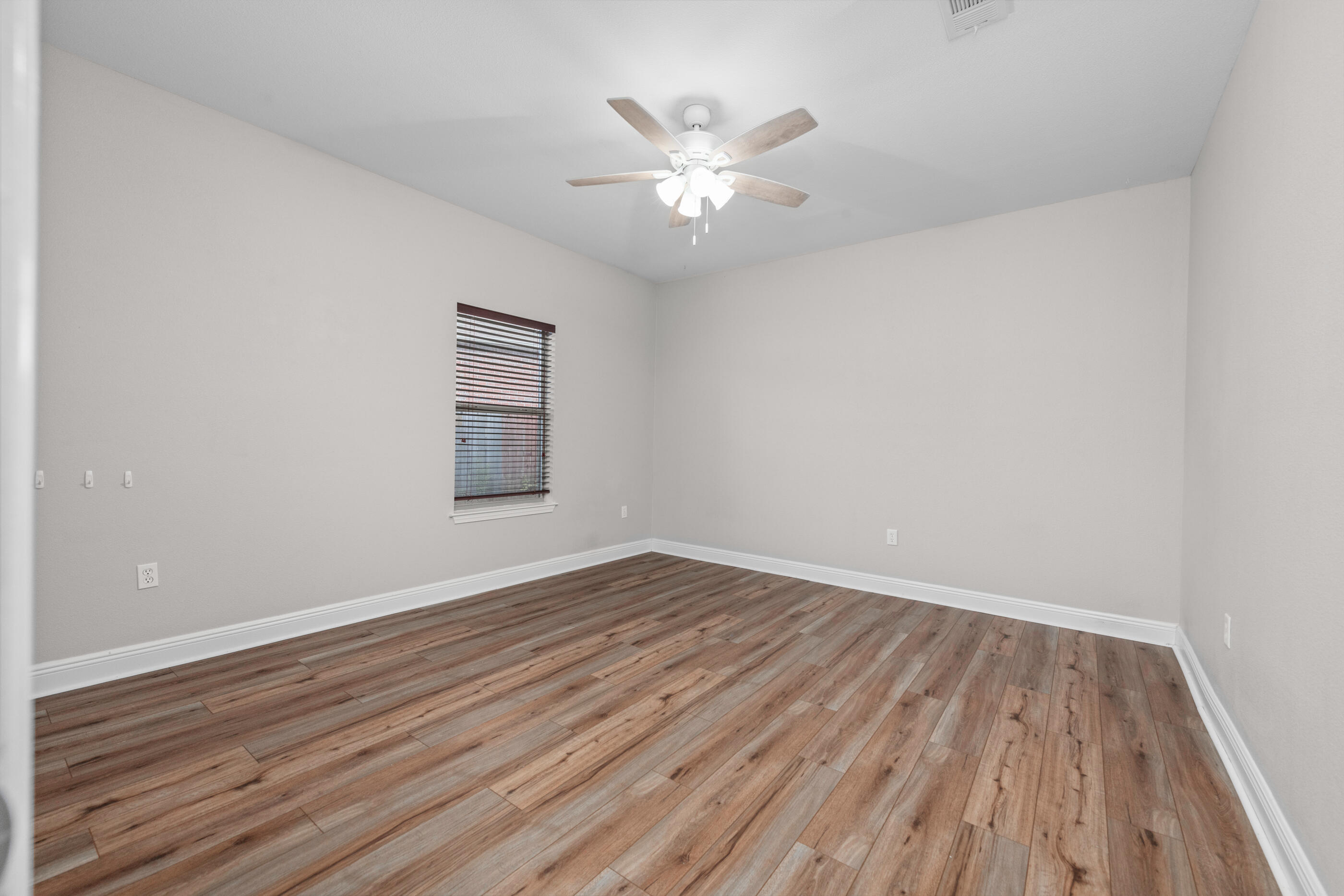 760 Lime Lane Crestview, FL 32536 - Photo 39 of 46 wooden floor in an empty room with a window