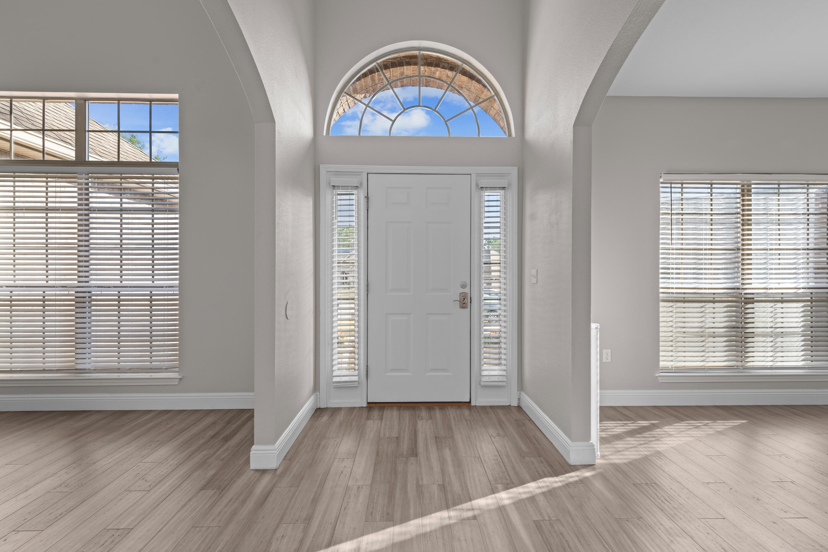 760 Lime Lane Crestview, FL 32536 - Photo 4 of 46 an empty room with wooden floor mirror and windows
