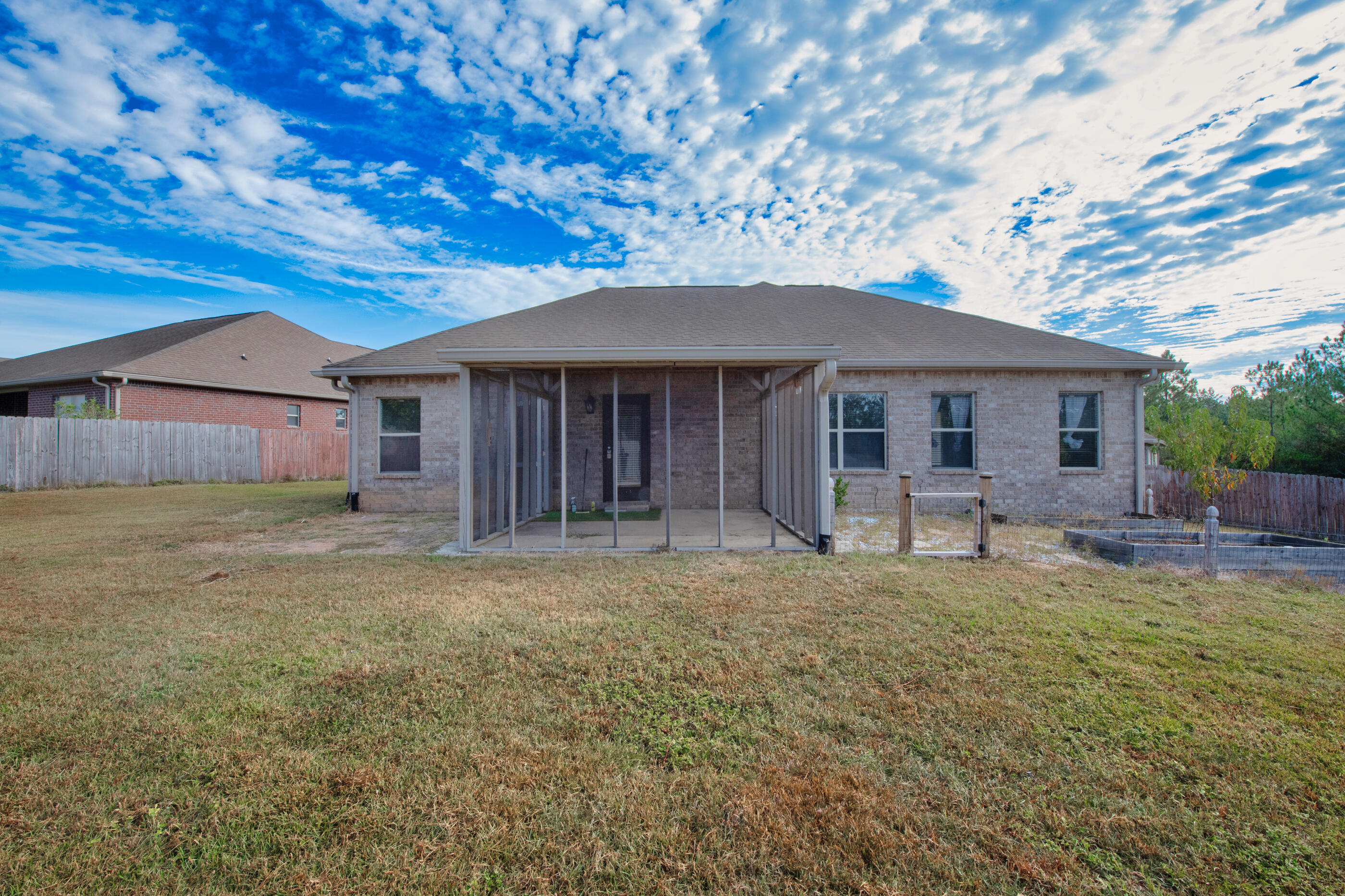 760 Lime Lane Crestview, FL 32536 - Photo 42 of 46 a front view of a house with a garden and porch