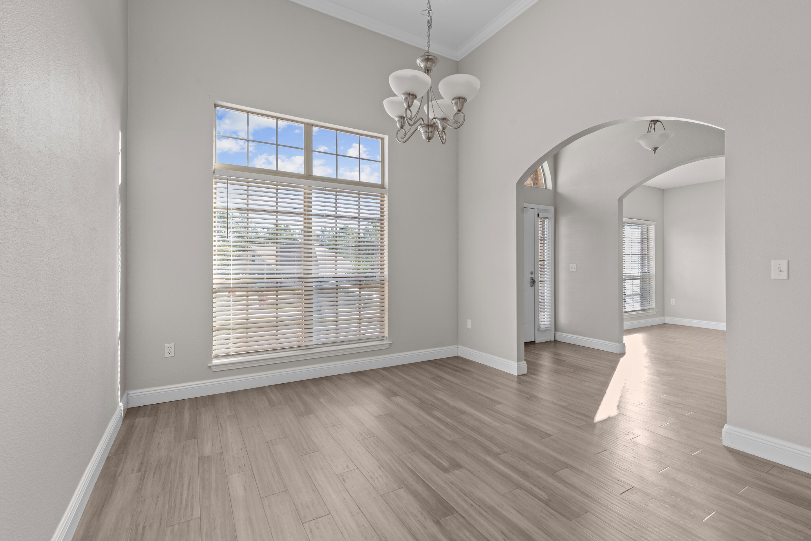 760 Lime Lane Crestview, FL 32536 - Photo 5 of 46 a view of an empty room with wooden floor and a window