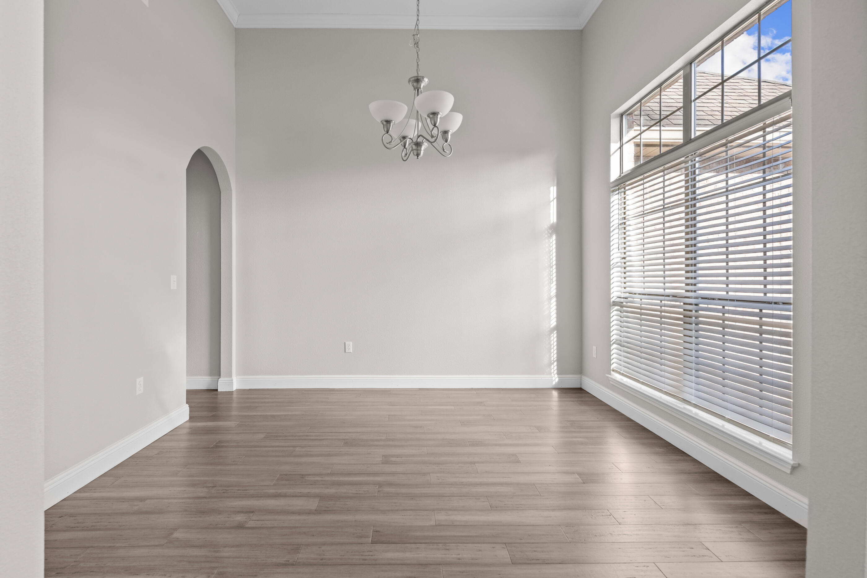 760 Lime Lane Crestview, FL 32536 - Photo 7 of 46 an empty room with wooden floor and windows