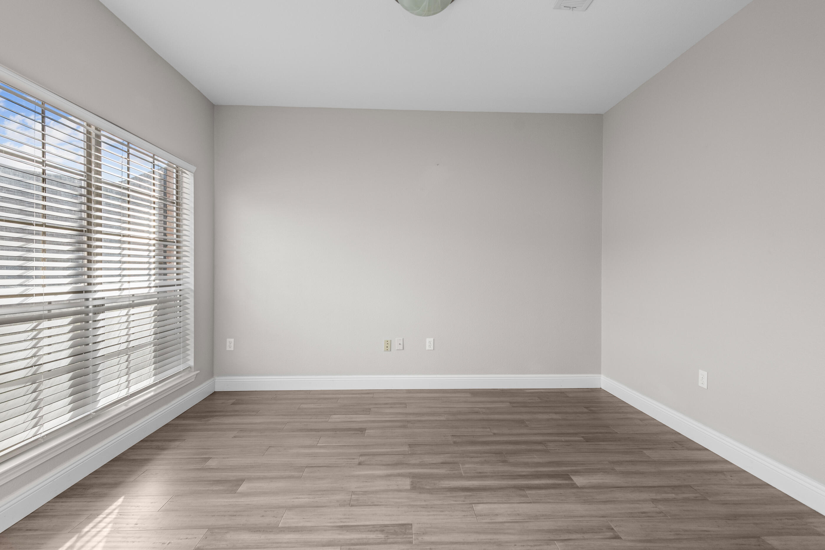 760 Lime Lane Crestview, FL 32536 - Photo 9 of 46 a view of an empty room with wooden floor and a window