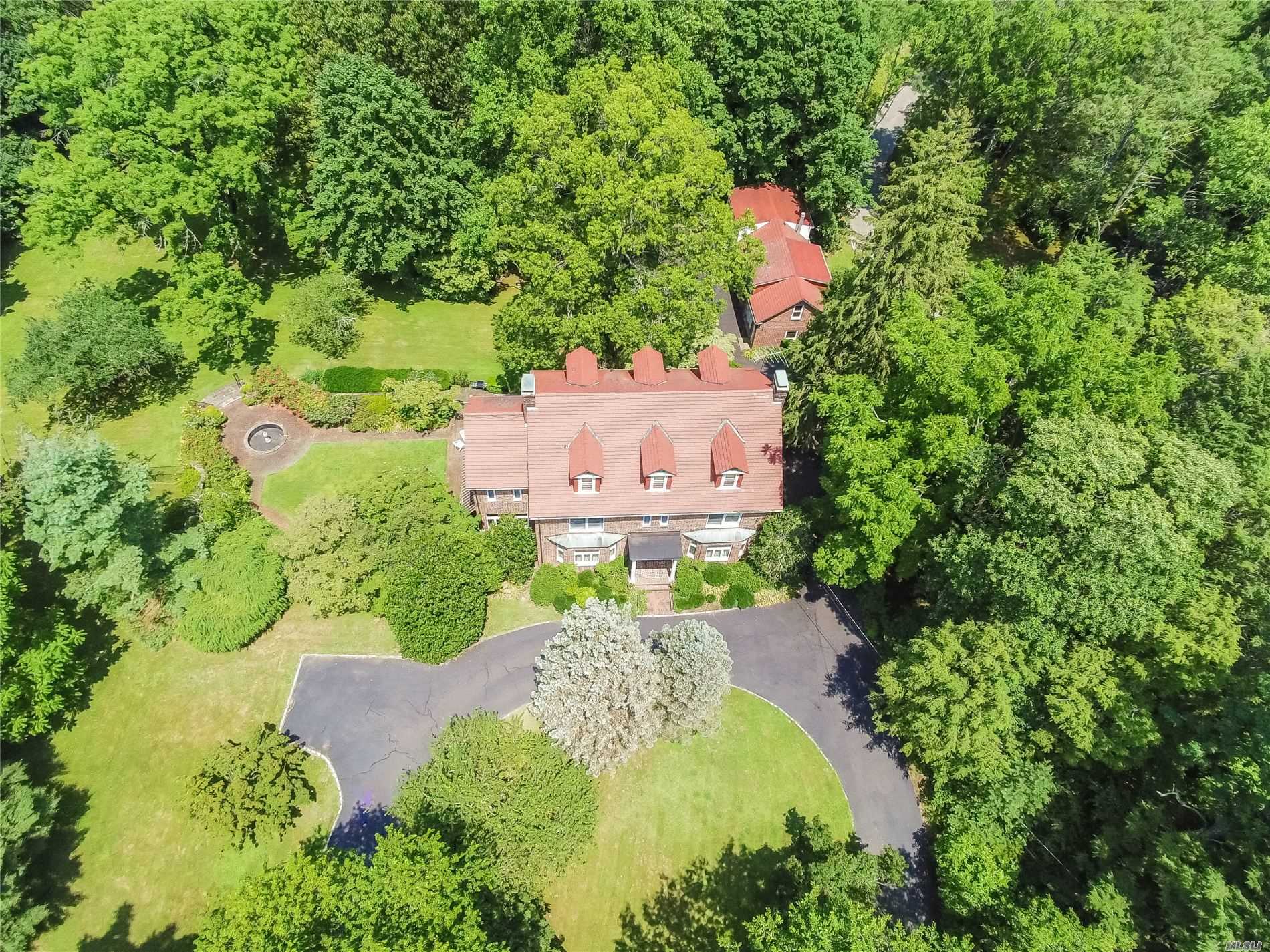 73 Ryefield Road Locust Valley, NY 11560 - Photo 1 of 1 an aerial view of a house with a yard and trees