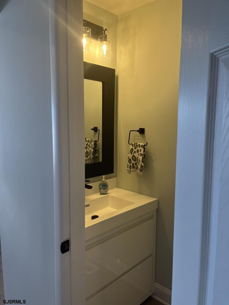 136 44th Street South, Unit A Brigantine, NJ 08203 - Photo 12 of 19 a bathroom with a sink and a mirror