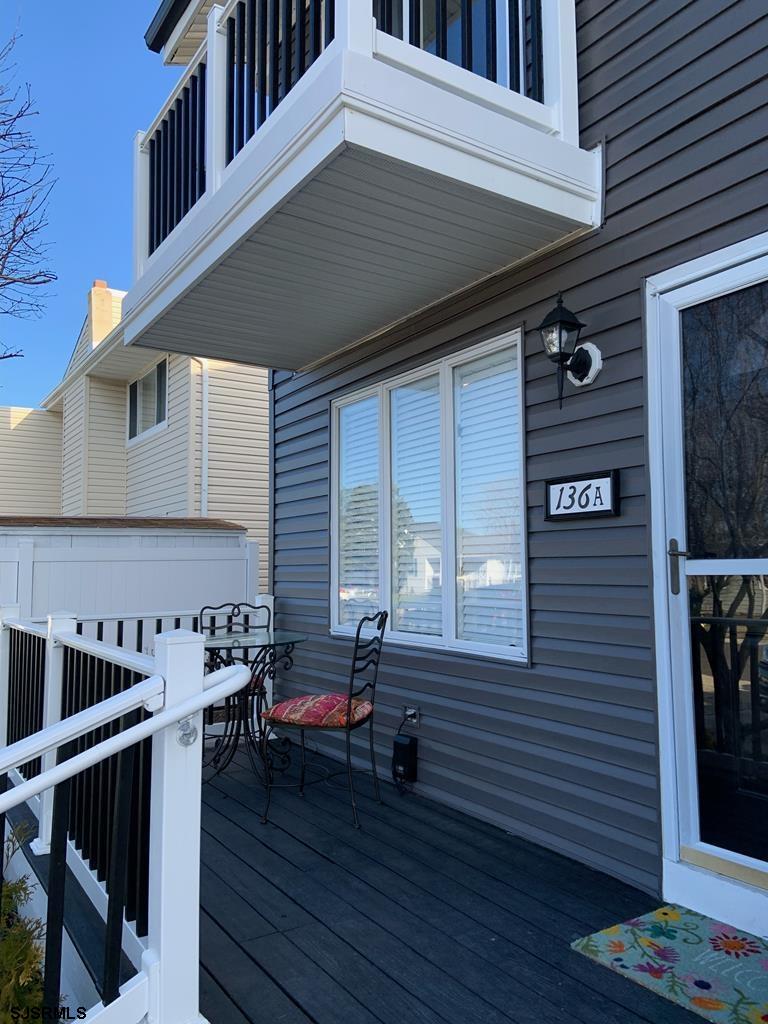 136 44th Street South, Unit A Brigantine, NJ 08203 - Photo 2 of 19 a view of a chairs and table on the wooden deck