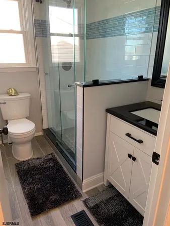 a bathroom with a sink toilet and shower