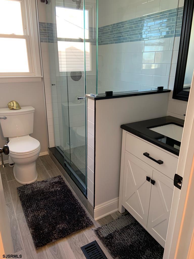 136 44th Street South, Unit A Brigantine, NJ 08203 - Photo 5 of 19 a bathroom with a sink toilet and shower