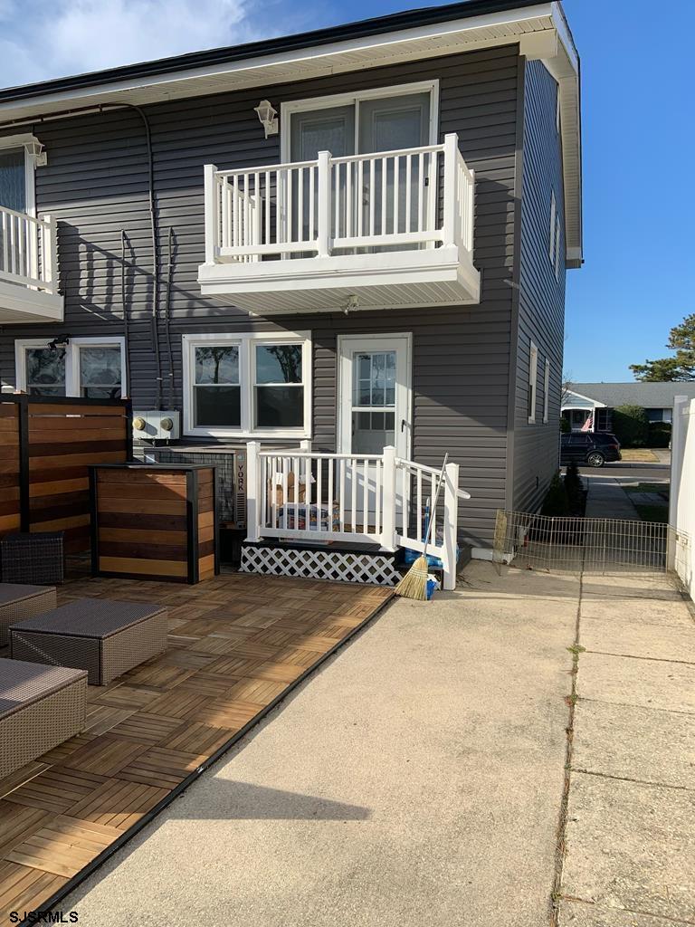 136 44th Street South, Unit A Brigantine, NJ 08203 - Photo 6 of 19 a view of a house with a barbeque and wooden stairs