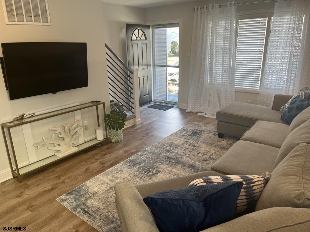 136 44th Street South, Unit A Brigantine, NJ 08203 - Photo 9 of 19 a living room with furniture and a flat screen tv