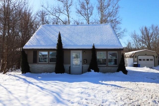 a view of a house with a yard covered in snow