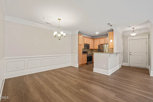 a view of a kitchen with wooden floor and a kitchen