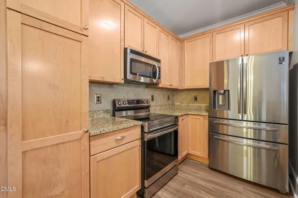 a kitchen with stainless steel appliances a refrigerator sink and microwave