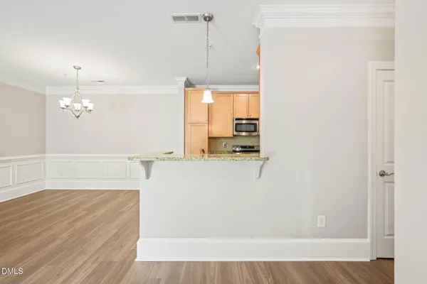 a view of a kitchen with wooden floor