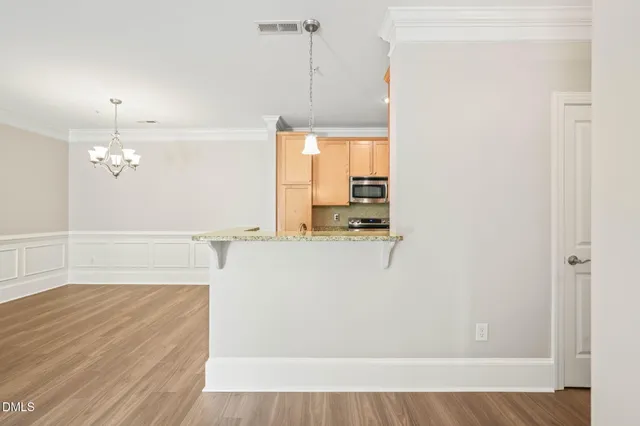 a view of a kitchen with wooden floor
