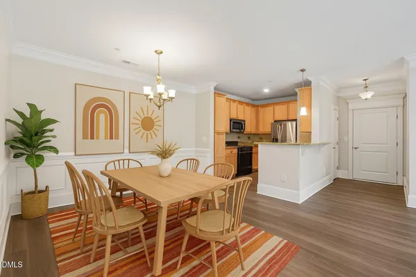 a view of a dining room with furniture and wooden floor