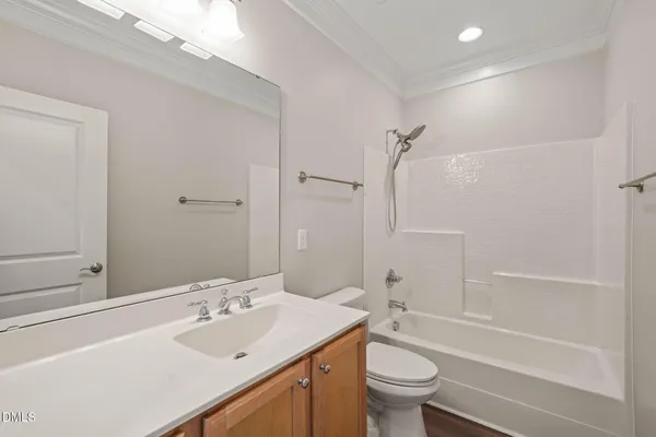 a bathroom with a sink a toilet and a large mirror