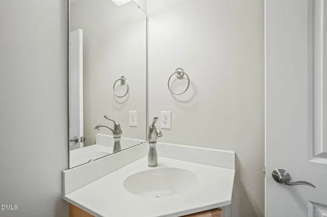 a bathroom with a sink and mirror