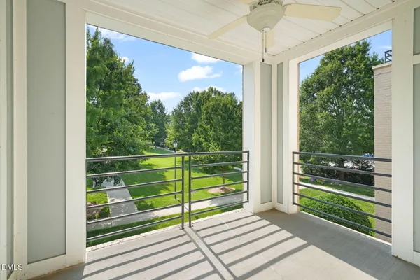 a view of a room with a large window and wooden floor