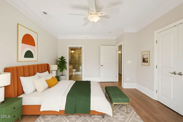 a bedroom with a bed and a painting on the wall