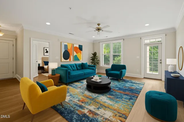 a living room with furniture a ceiling fan and a window