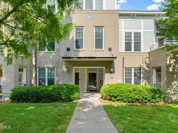 front view of a brick house with a yard