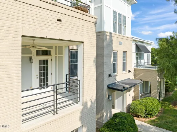 a view of a house with a small yard and wooden floor and fence