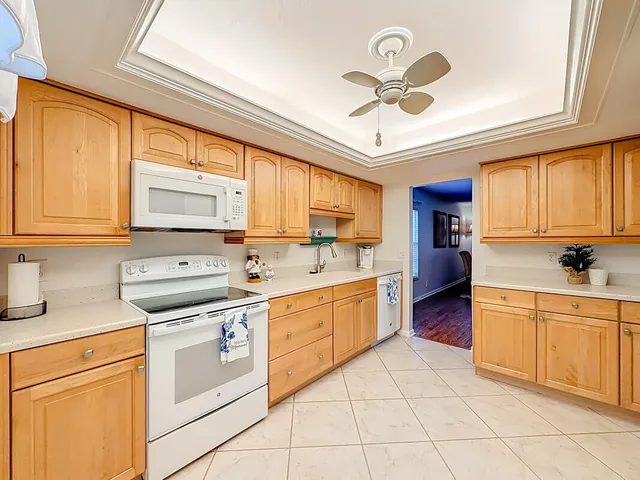 a kitchen with stainless steel appliances stove cabinets and a window