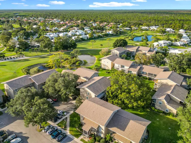 an aerial view of residential houses with outdoor space and swimming pool
