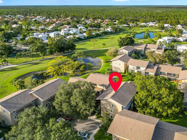 an aerial view of residential houses with outdoor space and river