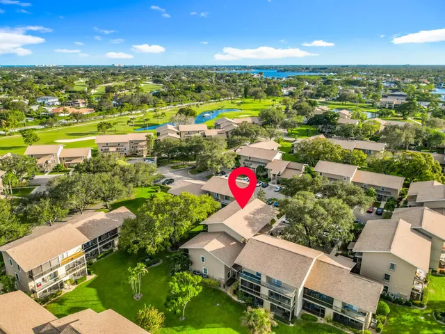an aerial view of residential houses with outdoor space and street view